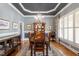 Formal dining room with elegant chandelier, wainscoting, and large windows with shutters at 1525 Marshall Farm St, Wake Forest, NC 27587