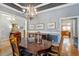 Well-lit dining room with decorative chandelier and views into kitchen and living spaces at 1525 Marshall Farm St, Wake Forest, NC 27587