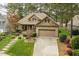 Picturesque brick and stone home with a well-maintained lawn, mature trees, and a spacious driveway at 1525 Marshall Farm St, Wake Forest, NC 27587