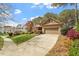 Attractive brick and stone home with a spacious driveway, green lawn, and mature trees in a neighborhood at 1525 Marshall Farm St, Wake Forest, NC 27587