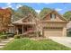 Charming brick and stone home with a well-manicured lawn and inviting curb appeal at 1525 Marshall Farm St, Wake Forest, NC 27587