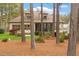 This home has a large yard with tall trees and an outdoor kitchen at 1525 Marshall Farm St, Wake Forest, NC 27587