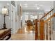 Inviting foyer with hardwood floors, staircase, and view to the living room with fireplace at 1525 Marshall Farm St, Wake Forest, NC 27587