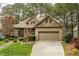 Beautiful home with a brick and stone facade, well-maintained lawn, and an attached two-car garage at 1525 Marshall Farm St, Wake Forest, NC 27587