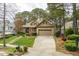 Charming brick home featuring a manicured lawn, lush landscaping, and a convenient two-car garage at 1525 Marshall Farm St, Wake Forest, NC 27587