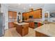 Large kitchen with granite counters, wood cabinets, stainless appliances, and kitchen island at 1525 Marshall Farm St, Wake Forest, NC 27587