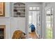 Bright living space featuring built-in shelves, a cozy blue couch, and a window with white shutters at 1525 Marshall Farm St, Wake Forest, NC 27587