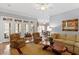Cozy living room with plush seating, unique coffee table, and natural light streaming through the windows at 1525 Marshall Farm St, Wake Forest, NC 27587