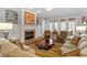 Comfortable living room with fireplace, built-in shelving, and large windows offering plenty of natural light at 1525 Marshall Farm St, Wake Forest, NC 27587