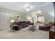 Bright bonus room features a cozy window seat, a ceiling fan, and comfortable leather seating at 1525 Marshall Farm St, Wake Forest, NC 27587