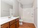 Functional bathroom featuring a sink vanity, tub, and wooden floors at 1607 Willowcrest Rd, Durham, NC 27703