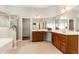 Luxurious bathroom boasting double vanity, glass shower, and walk-in closet access at 1607 Willowcrest Rd, Durham, NC 27703