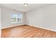 Well-lit bedroom with wood flooring and a window overlooking the neighborhood at 1607 Willowcrest Rd, Durham, NC 27703