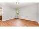 Cozy bedroom with wood flooring and a bright window offering natural light at 1607 Willowcrest Rd, Durham, NC 27703