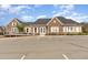 Community clubhouse featuring stone facade, ample parking, and manicured landscaping at 1607 Willowcrest Rd, Durham, NC 27703