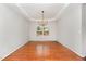 Bright dining room featuring hardwood floors, a tray ceiling, and a modern chandelier at 1607 Willowcrest Rd, Durham, NC 27703