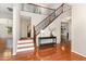 Grand foyer with hardwood floors, staircase, and elegant console table at 1607 Willowcrest Rd, Durham, NC 27703