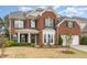 Beautiful brick home featuring a welcoming front porch and well-maintained landscaping at 1607 Willowcrest Rd, Durham, NC 27703