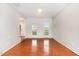 Hallway view showcasing wood floors, neutral paint and an entry way with natural light at 1607 Willowcrest Rd, Durham, NC 27703