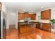 Open kitchen featuring an island with granite countertops and stainless steel appliances at 1607 Willowcrest Rd, Durham, NC 27703