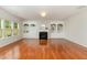 Cozy living room featuring a fireplace, built-in shelving, and hardwood floors at 1607 Willowcrest Rd, Durham, NC 27703