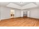 Large living room with wood floors, featuring doors to other rooms and upstairs at 1607 Willowcrest Rd, Durham, NC 27703