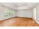 Spacious living room with wood floors and ample natural light from multiple windows at 1607 Willowcrest Rd, Durham, NC 27703