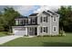 Charming two-story home with gray siding, black shutters, attached garage, and a well-manicured lawn at 1904 Harrell Cove Ct # 173 Eldorado Cl, Fuquay Varina, NC 27526