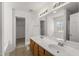 Bright bathroom with double sinks, wood cabinets, and a separate bathtub at 1905 Maple Sugar Ln, Fuquay Varina, NC 27526