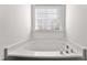 A luxurious soaking bathtub beneath a window with adjustable blinds at 1905 Maple Sugar Ln, Fuquay Varina, NC 27526
