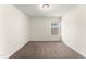 Bright bedroom features neutral walls, cozy carpet, and a window providing natural light at 1905 Maple Sugar Ln, Fuquay Varina, NC 27526