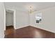 Cozy bedroom with hardwood floors, neutral walls, natural light, and a chandelier at 1905 Maple Sugar Ln, Fuquay Varina, NC 27526
