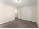 Empty bedroom with light walls, plush carpet, white doors, and ample closet space at 1905 Maple Sugar Ln, Fuquay Varina, NC 27526