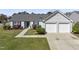 Charming single-story home featuring a well-maintained lawn and a two-car attached garage at 1905 Maple Sugar Ln, Fuquay Varina, NC 27526
