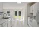 Bright kitchen with white cabinets, stainless steel appliances, and views to the backyard at 1905 Maple Sugar Ln, Fuquay Varina, NC 27526
