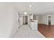 Spacious kitchen featuring all white appliances and cabinetry, tiled floors and opens to a living area at 1905 Maple Sugar Ln, Fuquay Varina, NC 27526