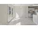 Bright kitchen with white tile flooring and glass paneled doors leading to backyard at 1905 Maple Sugar Ln, Fuquay Varina, NC 27526
