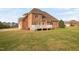Large brick house with a deck overlooking a spacious backyard at 21 W Paige Wynd Dr, Angier, NC 27501