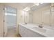 Bathroom featuring a double vanity with elegant faucets and bright overhead lighting at 21 W Paige Wynd Dr, Angier, NC 27501