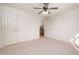 Neutral bedroom featuring plush carpeting, closet, and natural lighting at 21 W Paige Wynd Dr, Angier, NC 27501