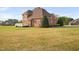 Brick house featuring a deck and a spacious lawn at 21 W Paige Wynd Dr, Angier, NC 27501