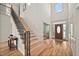 Bright foyer with soaring ceilings, staircase with wood treads, and elegant entry door at 21 W Paige Wynd Dr, Angier, NC 27501