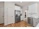 Well-designed kitchen featuring modern stainless steel appliances, white cabinetry, and hardwood floors at 21 W Paige Wynd Dr, Angier, NC 27501