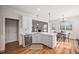 Bright kitchen featuring white cabinetry, stainless steel appliances, and hardwood flooring at 21 W Paige Wynd Dr, Angier, NC 27501
