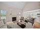 Bright living area with a fireplace, a comfortable seating arrangement and open to the kitchen at 21 W Paige Wynd Dr, Angier, NC 27501