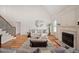 Spacious living room with a fireplace, neutral decor, and large windows filling the room with light at 21 W Paige Wynd Dr, Angier, NC 27501