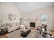 Cozy living room featuring a fireplace, vaulted ceiling, and neutral tones, providing an inviting atmosphere at 21 W Paige Wynd Dr, Angier, NC 27501