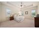 Spacious main bedroom with neutral tones, tray ceiling, and ample natural light at 21 W Paige Wynd Dr, Angier, NC 27501