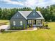 Charming two-story home with a well-manicured lawn and a welcoming front porch, nestled among mature trees at 2108 New Hope Church Rd, Chapel Hill, NC 27514