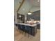 Kitchen island with seating, granite countertops, modern appliances, pendant lights, and custom cabinetry at 2108 New Hope Church Rd, Chapel Hill, NC 27514